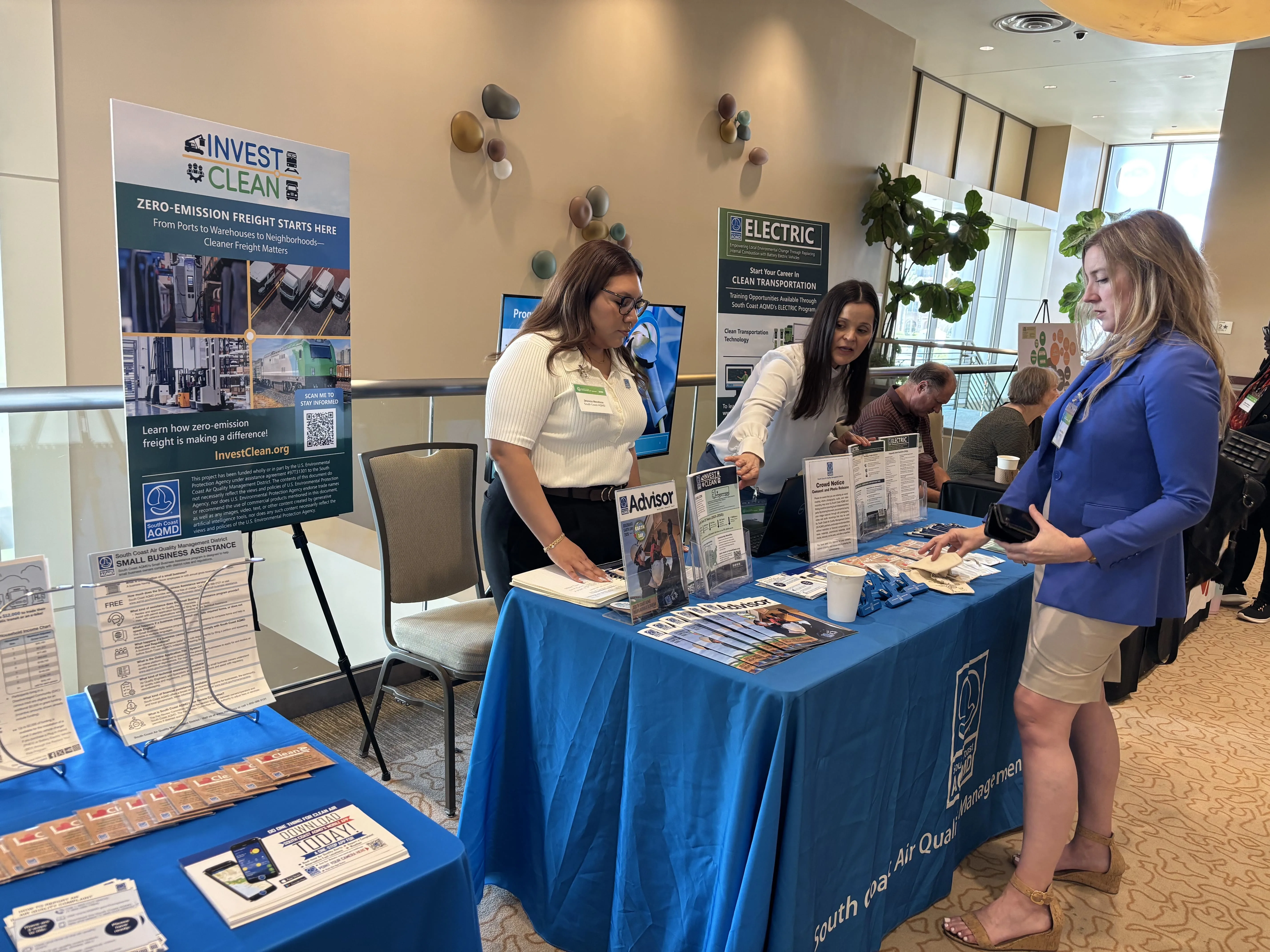 South Coast AQMD registration counter with Invest Clean brochures and promotional items